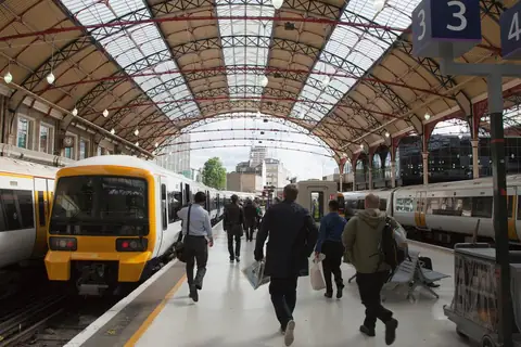 A Southeastern train at a platform under the roof of Victoria station
